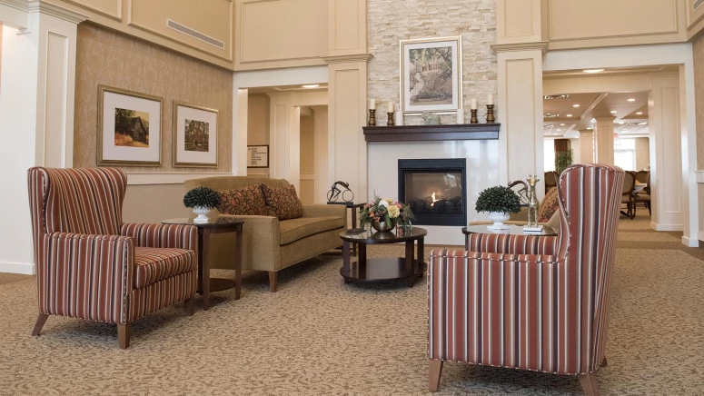 Couches and armchairs next to a fireplace in Sage Hill retirement home