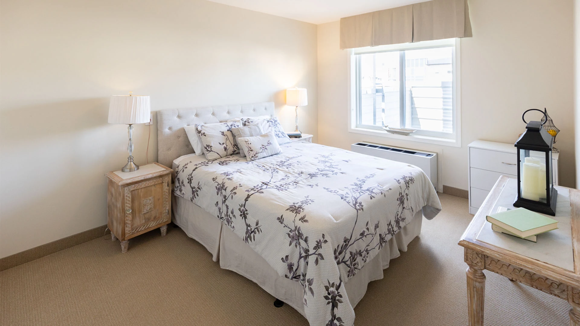 Bedroom with white bedding with purple flowers