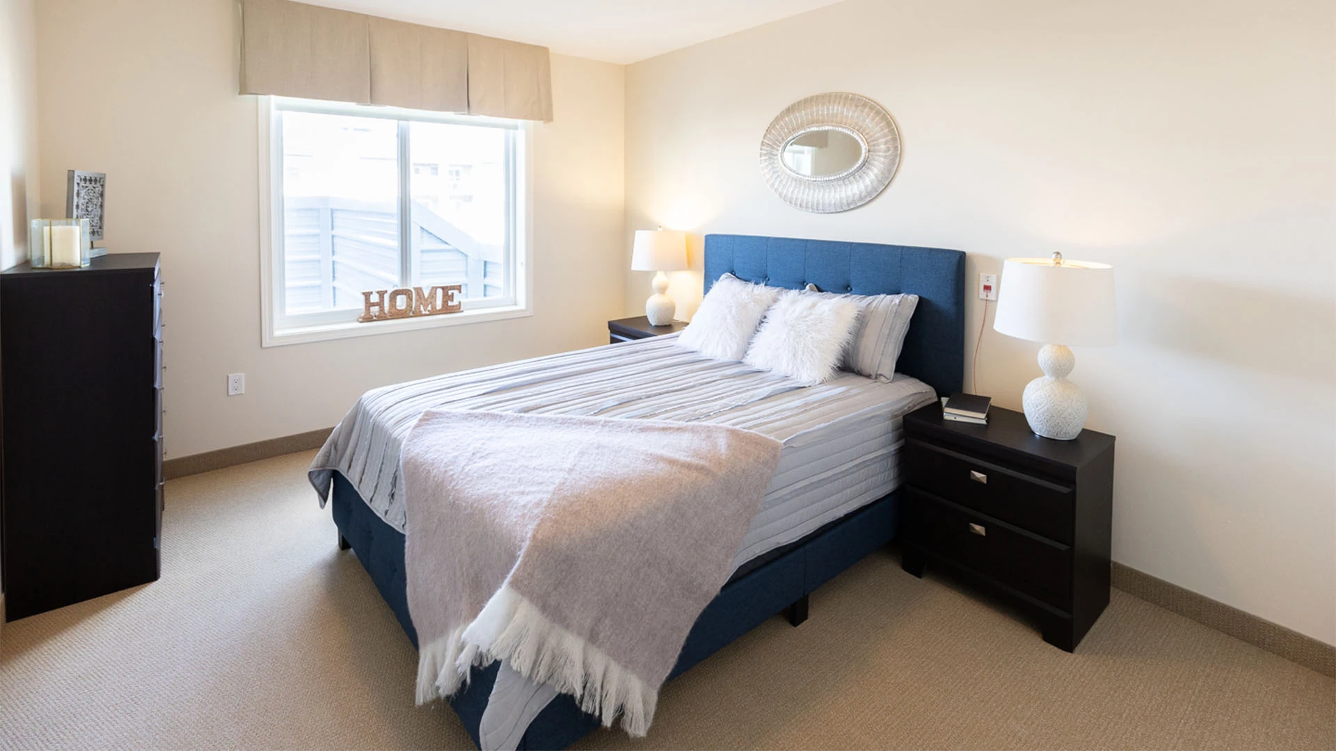 Bedroom with blue bed frame and light grey bedding
