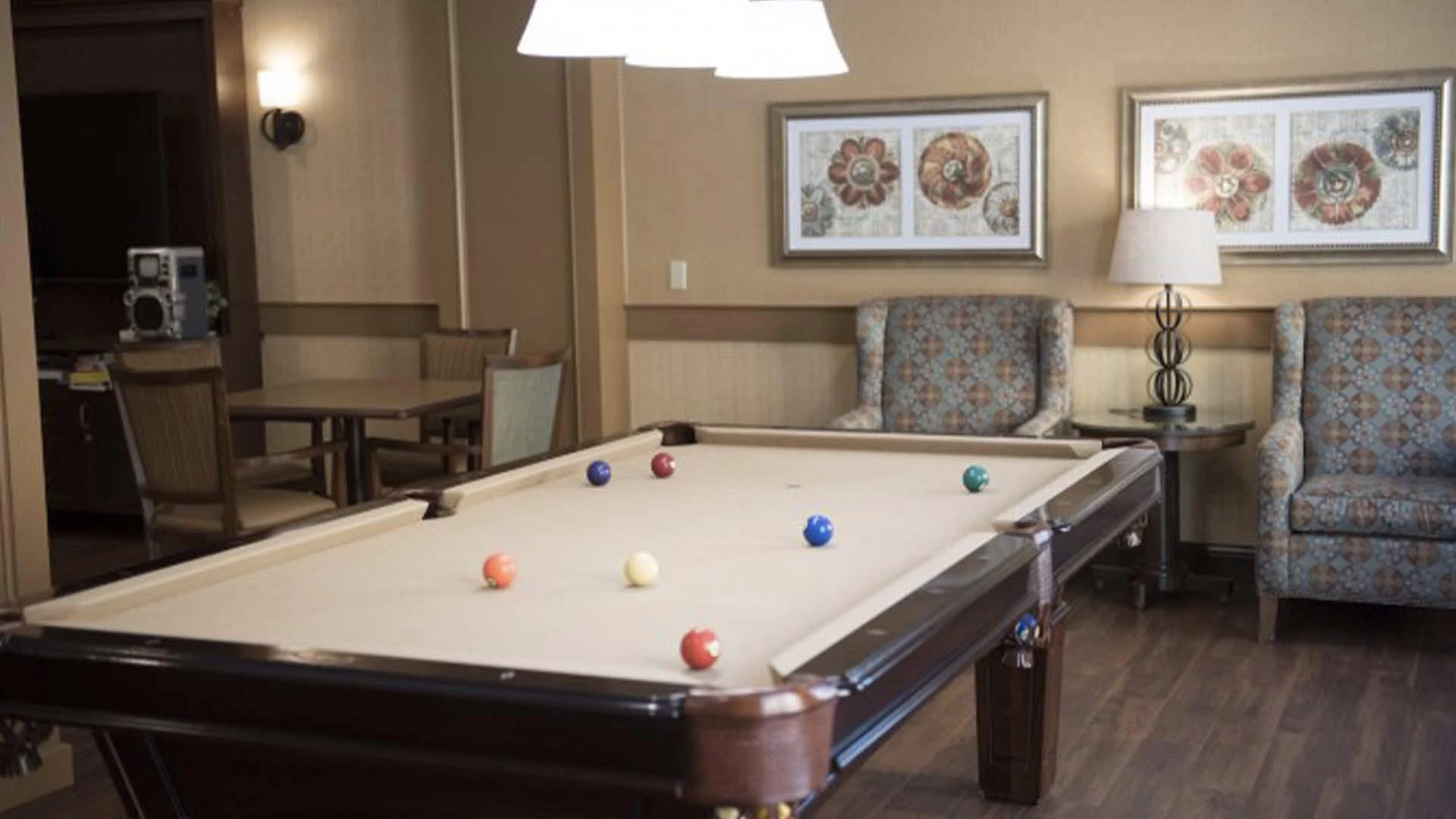 A pool table and armchairs in the Sage Hill retirement home games room
